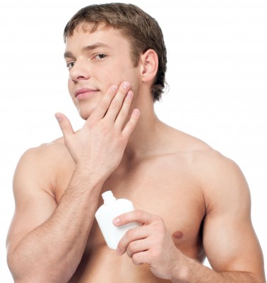 man moisturizing his face after shave